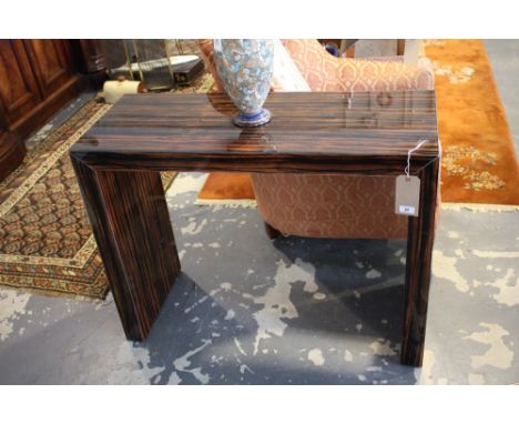 A designer simulated coromandle glass console table. Width 100cm.