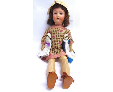 A SIMON &amp; HALBIG FOR KAMMER &amp; REINHARDT BISQUE SOCKET HEAD DOLL  with a brown wig, sleeping blue-grey glass eyes, and