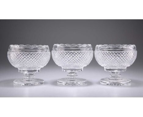 A SET OF THREE WATERFORD GLASS BOWLS the globular bodies are completely hobnail cut with scalloped rims, all resting on a twe