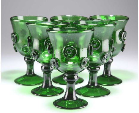 A SET OF SIX LATE 18TH CENTURY GLASS ROEMERS, POSSIBLY BRISTOL each bowl with pinched roundels, raised on a domed circular fo