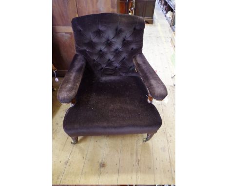 A Victorian walnut and button upholstered open arm occasional chair, by Howard &amp; Sons,&nbsp;both&nbsp;rear casters stampe