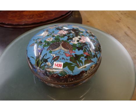 A Japanese cloisonne enamel circular box and cover, decorated with birds amongst flowers, 30.5cm diameter. (s.d.) 