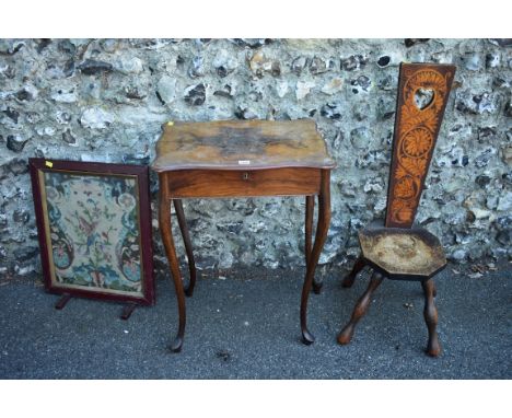 A Victorian walnut work table having hinged rising lid enclosing compartments 54cm wide; together with a pokerwork spinning c