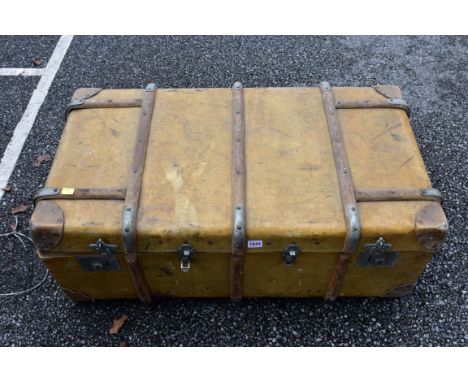 A wood bound travelling trunk, containing an Eastern prayer mat and three umbrellas.&nbsp;This lot can only be collected on S