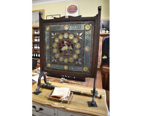 A Victorian stained and leaded glass panel,&nbsp;54.5 x 56cm, (minor cracks), mounted in a 1920s oak firescreen.&nbsp; 