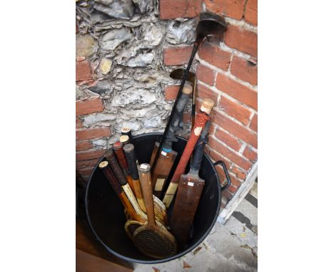 A quantity of vintage sporting equipment, to include: tennis rackets; cricket bats and golf clubs. 