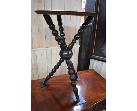 An Eastern brass tray top table, on ebonized bobbin turned tripod 'cat' stand, 34cm diameter.&nbsp; 