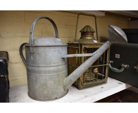 A vintage galvanised watering can, with rose; together with a brass hanging lantern.&nbsp; 