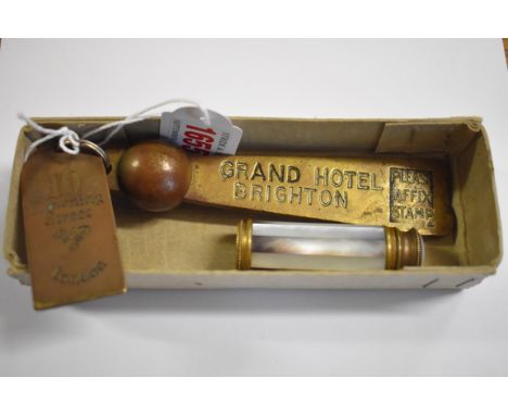 An old brass keyring, inscribed 'Grand Hotel, Brighton, Room No...'; together with another brass key ring; and an incomplete 
