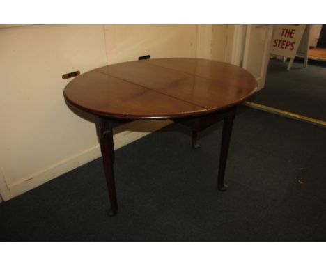 A George III mahogany drop-leaf gate-leg dining table, with oval top on turned tapered legs to pad feet 120.5cm fully extende