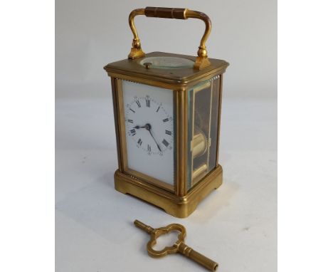 A brass and bevelled glass cased repeater carriage clock, the movement stamped Paris, striking on a gong, with key,16.5cm hig