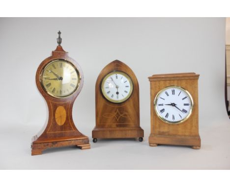 An Edwardian style lancet shaped mantle clock, the circular white enamel dial with Roman numerals, 28.5cm high, with pendulum