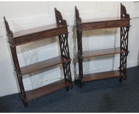 A pair of Chinese Chippendale style hanging wall shelves with top shelf of two small fretwork drawers and two further shelves