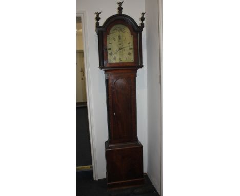 An early 19th century mahogany longcase clock with twelve inch brass dial marked J Higman St Austell with calendar aperture a