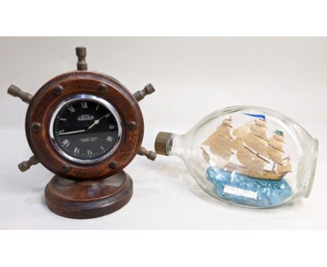 A British Jaeger 8 day novelty clock framed within a ship's wheel, the black circular dial with white Roman numerals, 18.5cm 