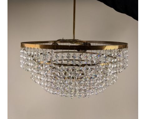 A circular brass six tier chandelier light fitting with hanging glass droplets, 43cm diameter