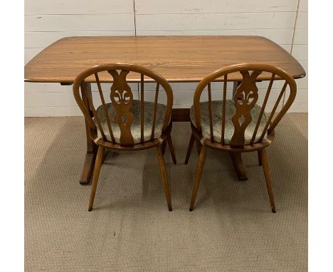 An Ercol table and two Ercol chairs (W152cm D84cm)