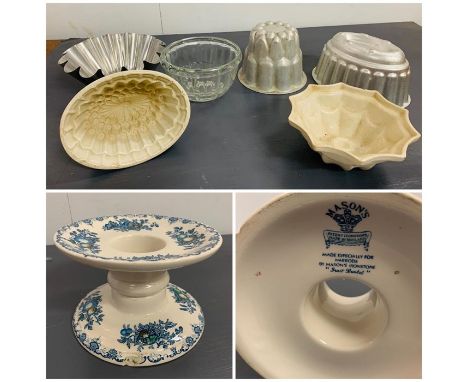 A selection of vintage jelly moulds and a Mason's china ham stand 