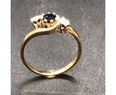 A 9ct gold ring with central sapphire and diamond shoulders.