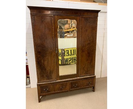 A triple wardrobe with two drawers under and mirror to door 