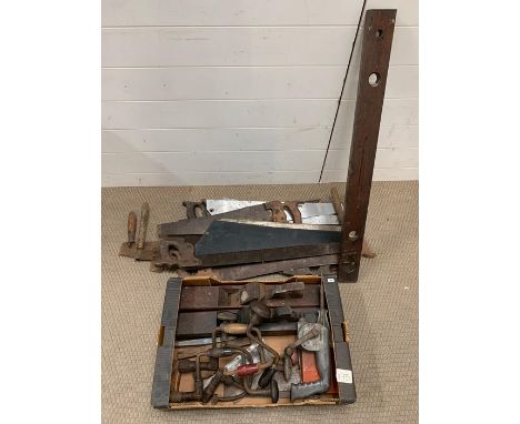 A selection of vintage push me, pull me saws, carpentry tools including plains and hammer drill