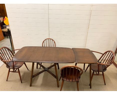 An Ercol elm dining table with extensions table/side table with four chairs (Main table 136cm x 75cm) (Side table 48cm x 75cm