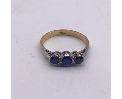 An 18ct three stone ring Size K