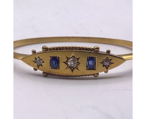 A Gold bangle, marked 15ct with diamonds and sapphires (8g)