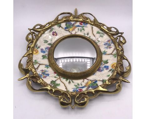 A Royal Staffordshire pottery plaque mounted in a brass decorative ring framing a convex mirror