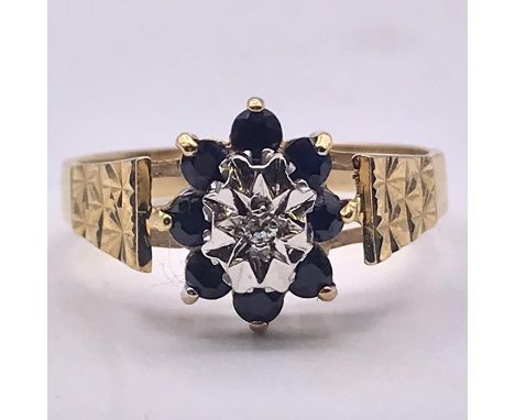A 9ct gold ring with white and blue stones. Size N