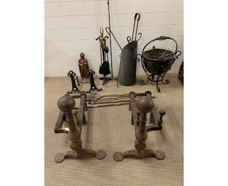 A large selection of fire side tools, buckets and a substantial pair of cast iron fire dogs 