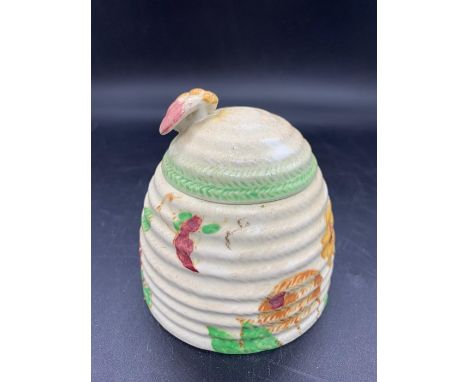 A hand painted honey pot by Clarice Cliff 