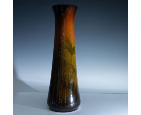 Designed by Matthew Andrew Daly, a tall flask-shaped glazed vase with hand painted ferns. Rookwood impressed stamp. Shape 804