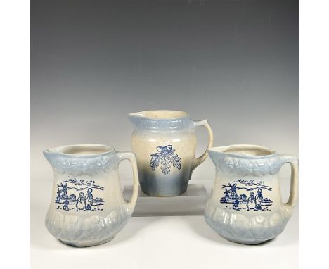 Beautiful trio of stoneware pitchers. Two are decorated with children gazing at a windmill and the third has an acorn with le