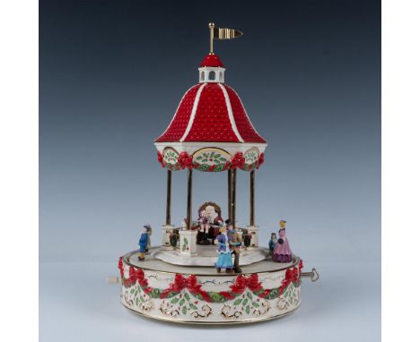 Limited edition musical centerpiece. Santa is seated in the center of the gazebo with a child on his lap and elves at his sid