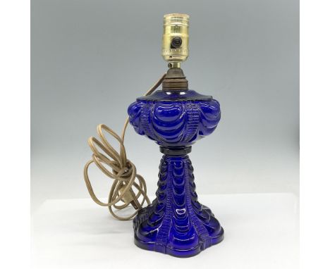 Deep blue glass with embossed pattern of drapes down tiered lamp. Twist switch for light function. Issued: 20th centuryDimens
