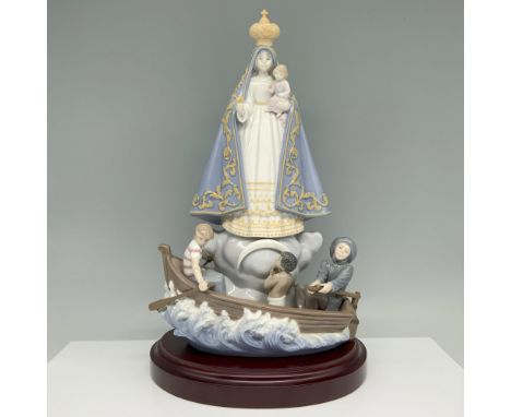 Glossy finish. Figure of a religious icon standing over a boat with children. Lladro backstamp. This item has a wooden base i
