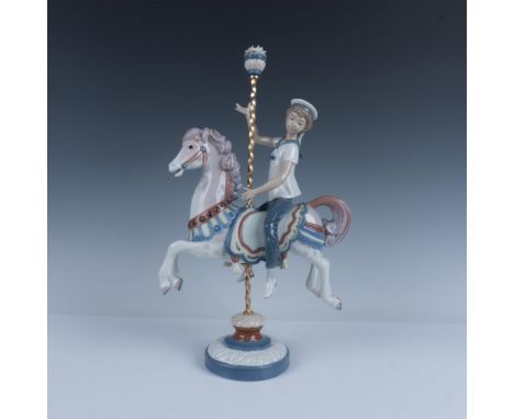 Glossy finish; Boy riding a decorated carrousel horse. Flower stopper on top of pole. Lladro backstamp. This item has its ori