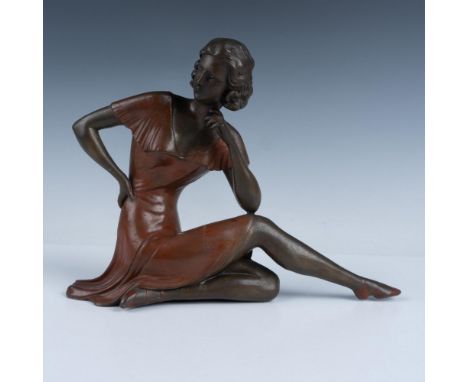 Gorgeous antique Art Deco patinated polychrome bronze spelter sculpture depicting a 1920s athletic woman dressed in a rust co
