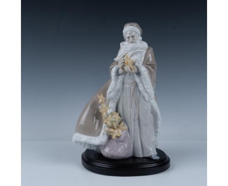 A dazzling glossy figure depicting a merry, bearded man in a long robe, holding up a star. Part of The Spirit of the Stars co