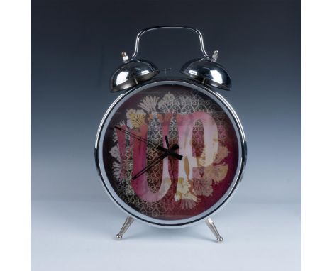 Stylish statement piece. Features a large analog clock with chrome silver metal exterior and a psychedelic art style design i