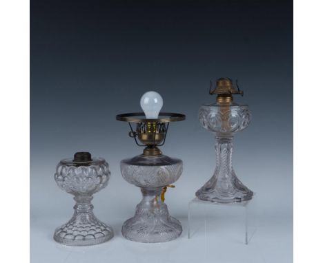 Extravagant trio of glass oil lamps that includes a Plume and Atwood MFG Co scalloped base lamp with a P&amp;A MFG Co backsta