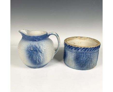 The blue and white stoneware pitcher has a poinsettia and trellis pattern. It measures 7.5"L x 6.5"W x 6.5"H. The crock is de