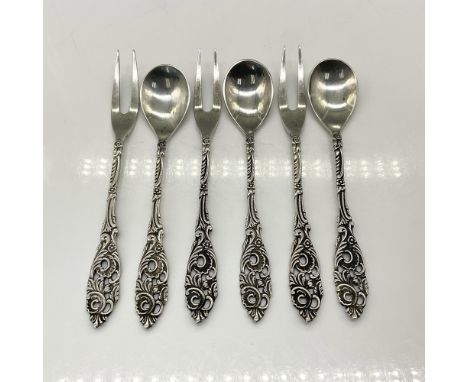 This small appetizer fork and spoon set is marked 90, indicating that 90 grams of silver were used for plating. The forks mea