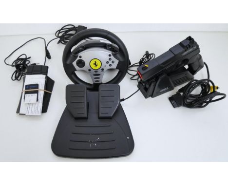 A Thrustmaster PlayStation steering wheel and pedals with a 4Gamers PS2 light gun with pedal and 8mb memory card