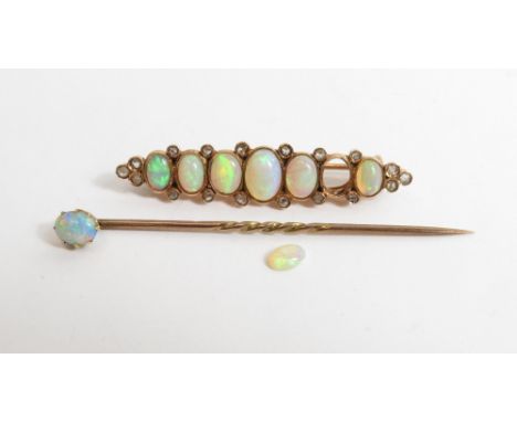 A late Victorian opal line brooch, unmarked, the seven graduated opals with rose diamond points and terminals, 4.5cm long; wi