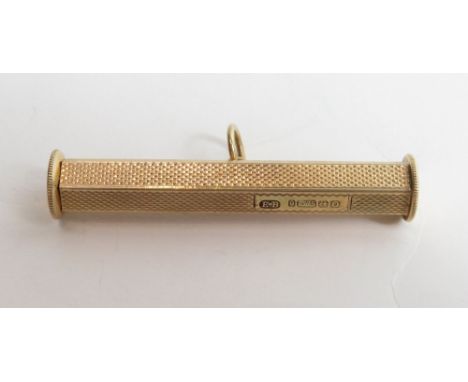 A 9 carat gold cigar piercer(?), the hexagonal body with engine turning, 4.8 cm long, 10 g gross