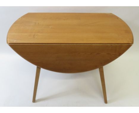 A mid century beech and elm Ercol table, 71cm high, 124cm long, 112cm deep