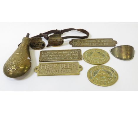 A brass powder flask, along with various brass plaques, 2009 military plate and other items