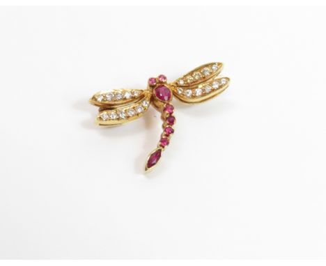An 18 carat gold diamond and ruby set dragonfly brooch, the wings set with small brilliant cut diamonds, eyes thorax and tail